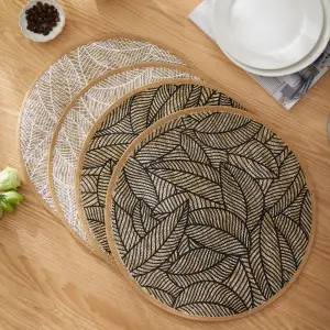 Runde Platzdeckchen mit Blattmuster in Schwarz und Weiß auf Holztisch